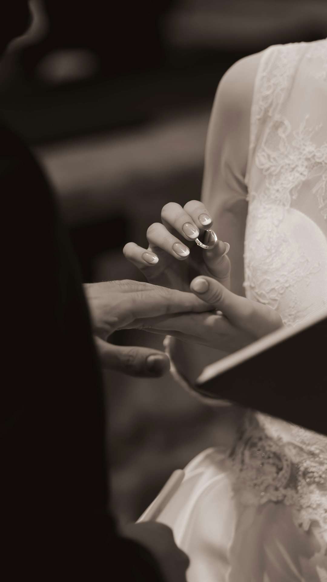 gallery-2 bride-placing-ring-on-grooms-finger-during-wedding-ceremony-jdqd4bhg6ms